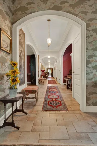 a living room with furniture a chandelier and a fireplace