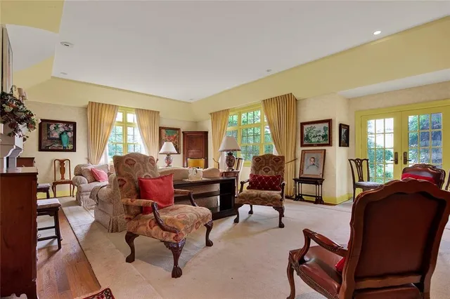 a living room with furniture fireplace and a large window