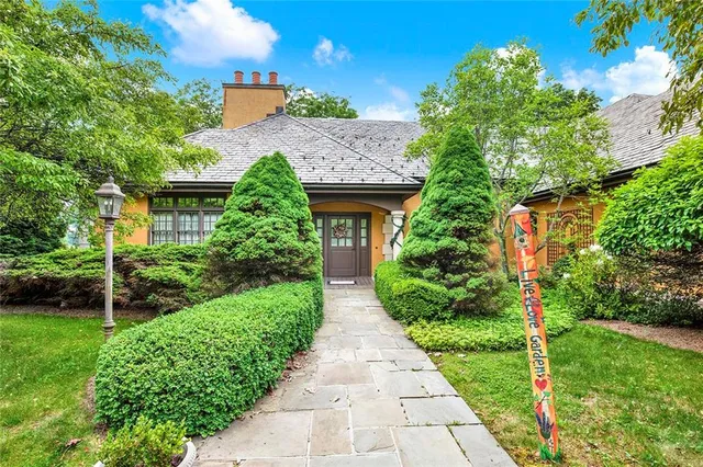 a front view of a house with garden