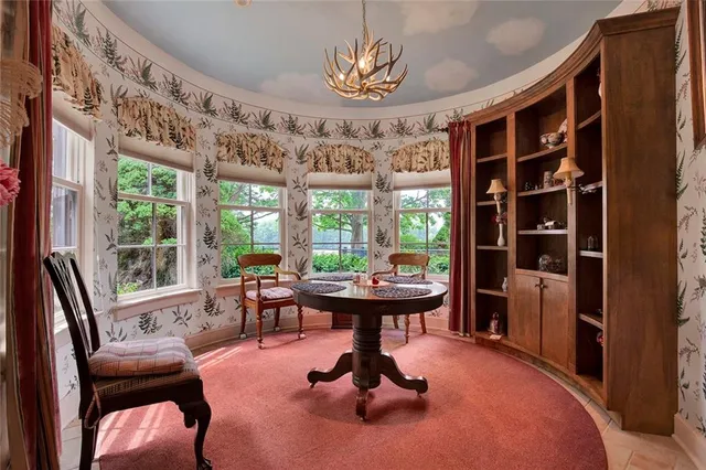 a view of a livingroom with furniture and large windows