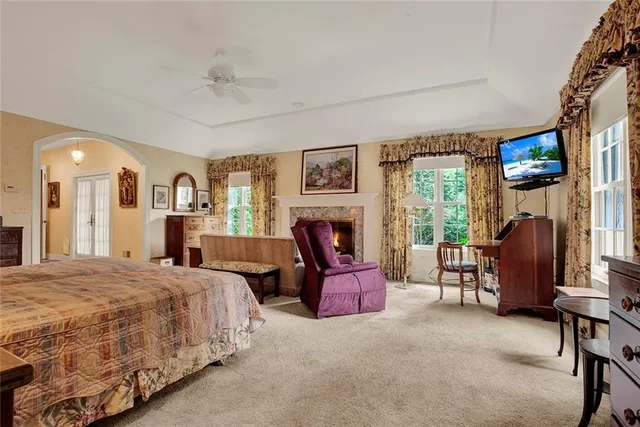 a spacious bedroom with a balcony a bed and a couch