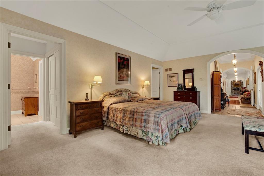 274 Rector Road Rector, PA 15677 - Photo 28 of 50 a spacious bedroom with a bed and a chandelier