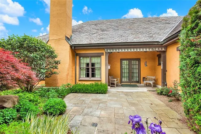 a front view of a house with garden