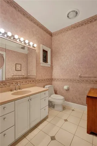 a bathroom with a toilet sink and mirror