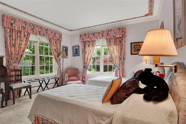 a bedroom with a bed and a large window