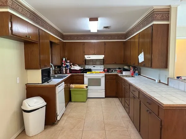 a kitchen with a sink appliances and cabinets