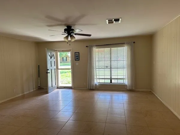 a view of n empty room with a window