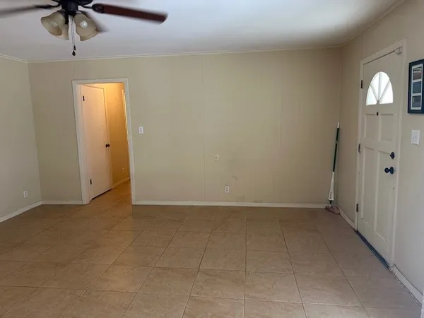 an empty room with a empty space and a ceiling fan