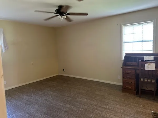 a view of a livingroom with wooden floor and windows