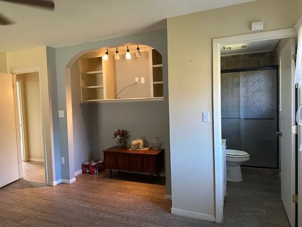 a bathroom with a toilet and a shower