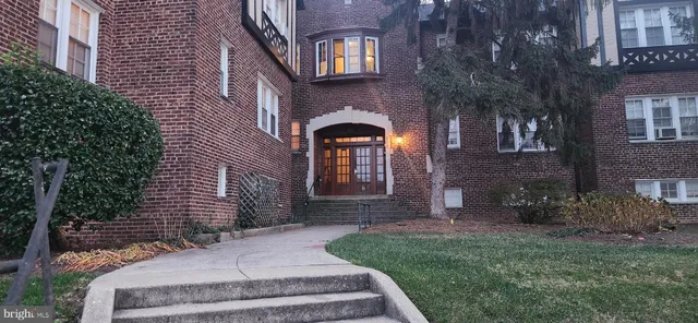 a front view of a house with brick walls and a yard