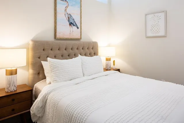 a bedroom with bed and painting on the wall