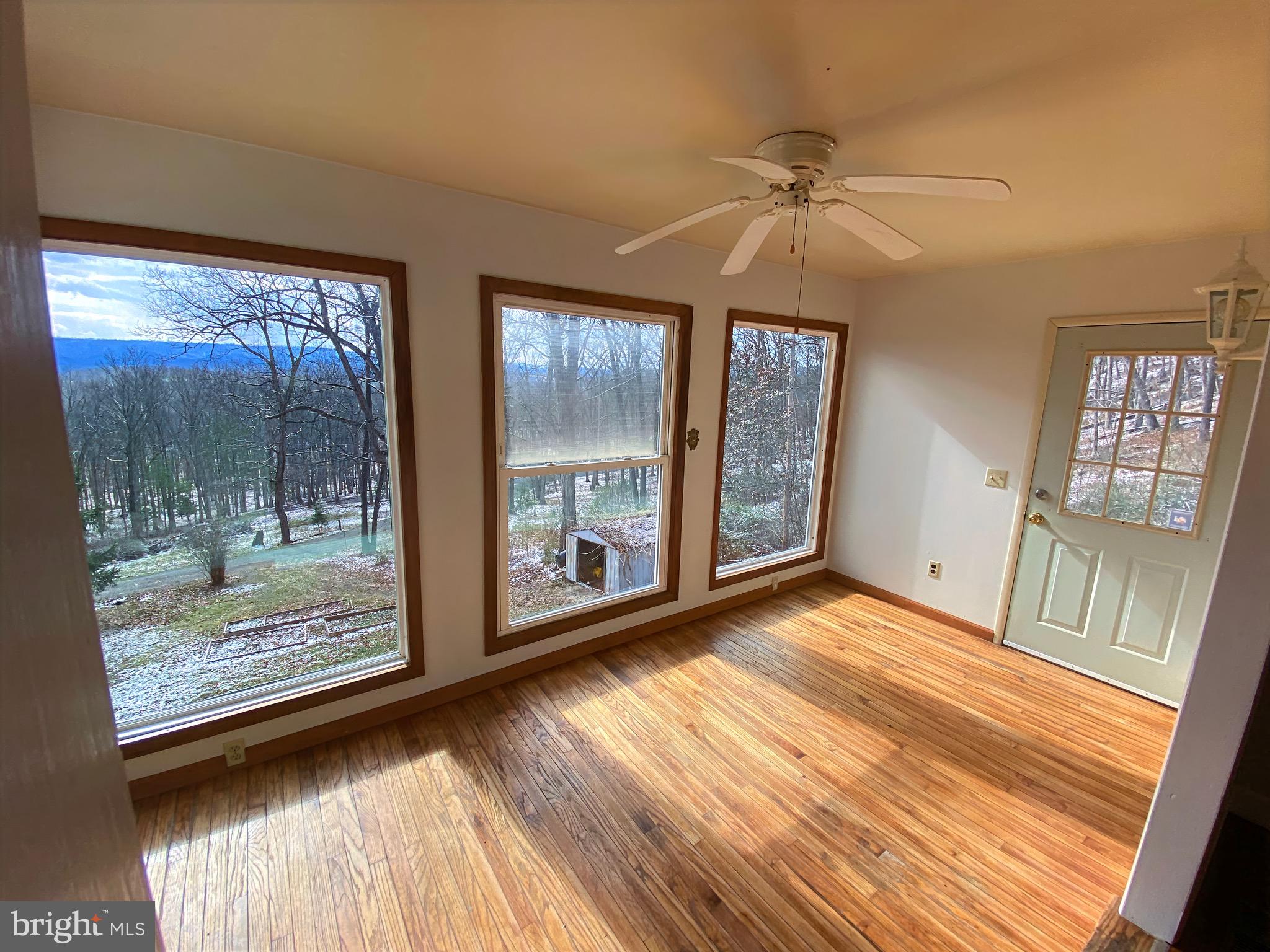 2932 Kerns School Road Springfield, WV 26763 - Photo 11 of 52 a view of an empty room with glass door and a window