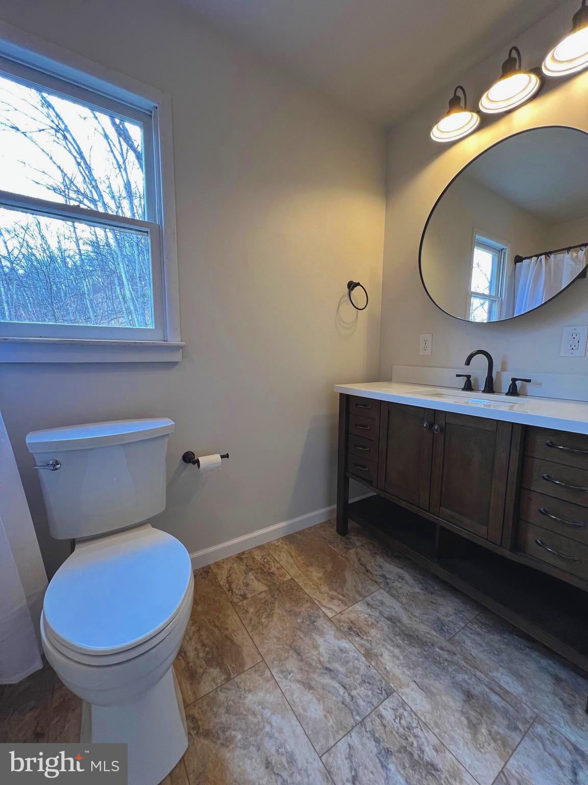 2932 Kerns School Road Springfield, WV 26763 - Photo 20 of 52 a bathroom with a toilet sink vanity and mirror