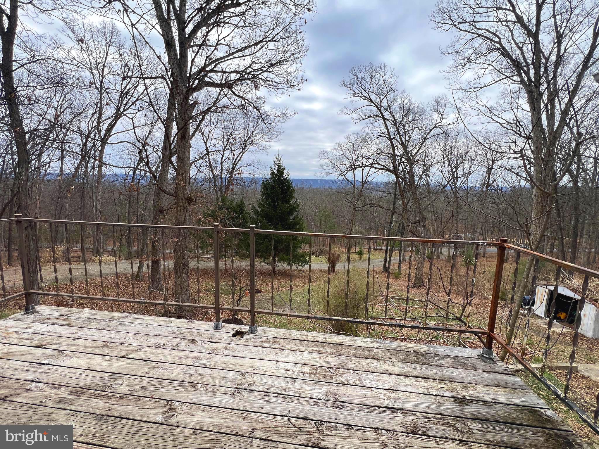 2932 Kerns School Road Springfield, WV 26763 - Photo 32 of 52 a view of a house with a wooden fence and trees