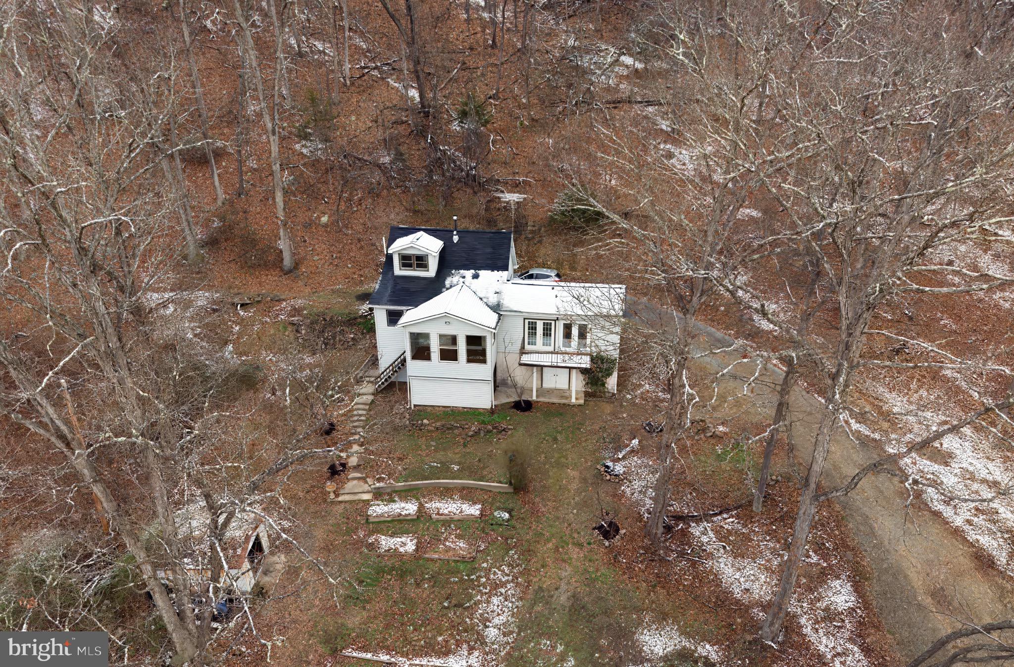 2932 Kerns School Road Springfield, WV 26763 - Photo 4 of 52 a view of a fire pit with large trees
