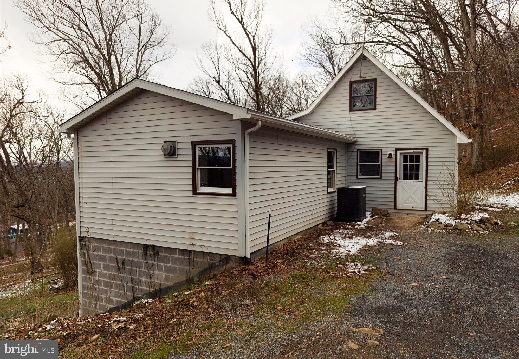 2932 Kerns School Road Springfield, WV 26763 - Photo 46 of 52 a view of a white house with a small yard and large tree