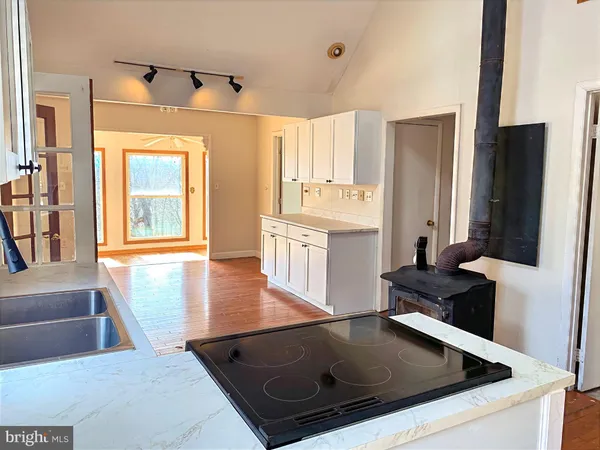 a kitchen with a refrigerator and a stove top oven