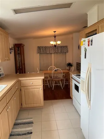 a kitchen with a cabinets and white appliances