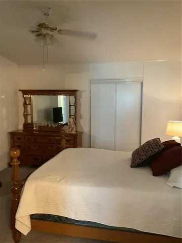 a bedroom with a bed and a tv