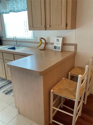 a kitchen with a table chairs and a window