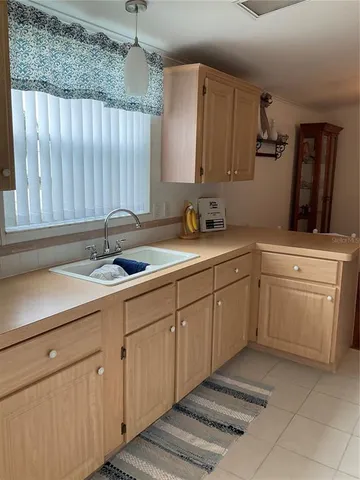 a kitchen with a sink and cabinets