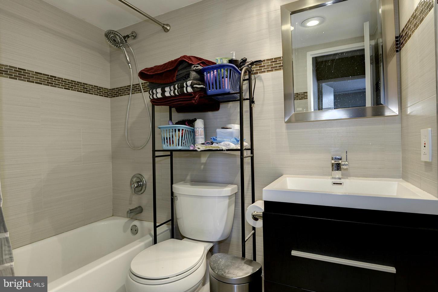 1250 4th Street Southwest, Unit W614 Washington, DC 20024 - Photo 10 of 22 a bathroom with a sink toilet vanity and shower