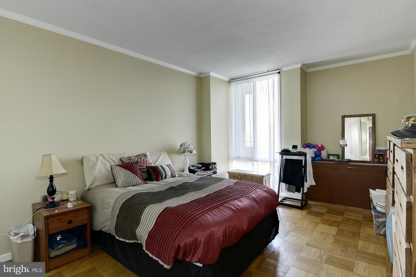 1250 4th Street Southwest, Unit W614 Washington, DC 20024 - Photo 11 of 22 a bedroom with a bed and wooden floor