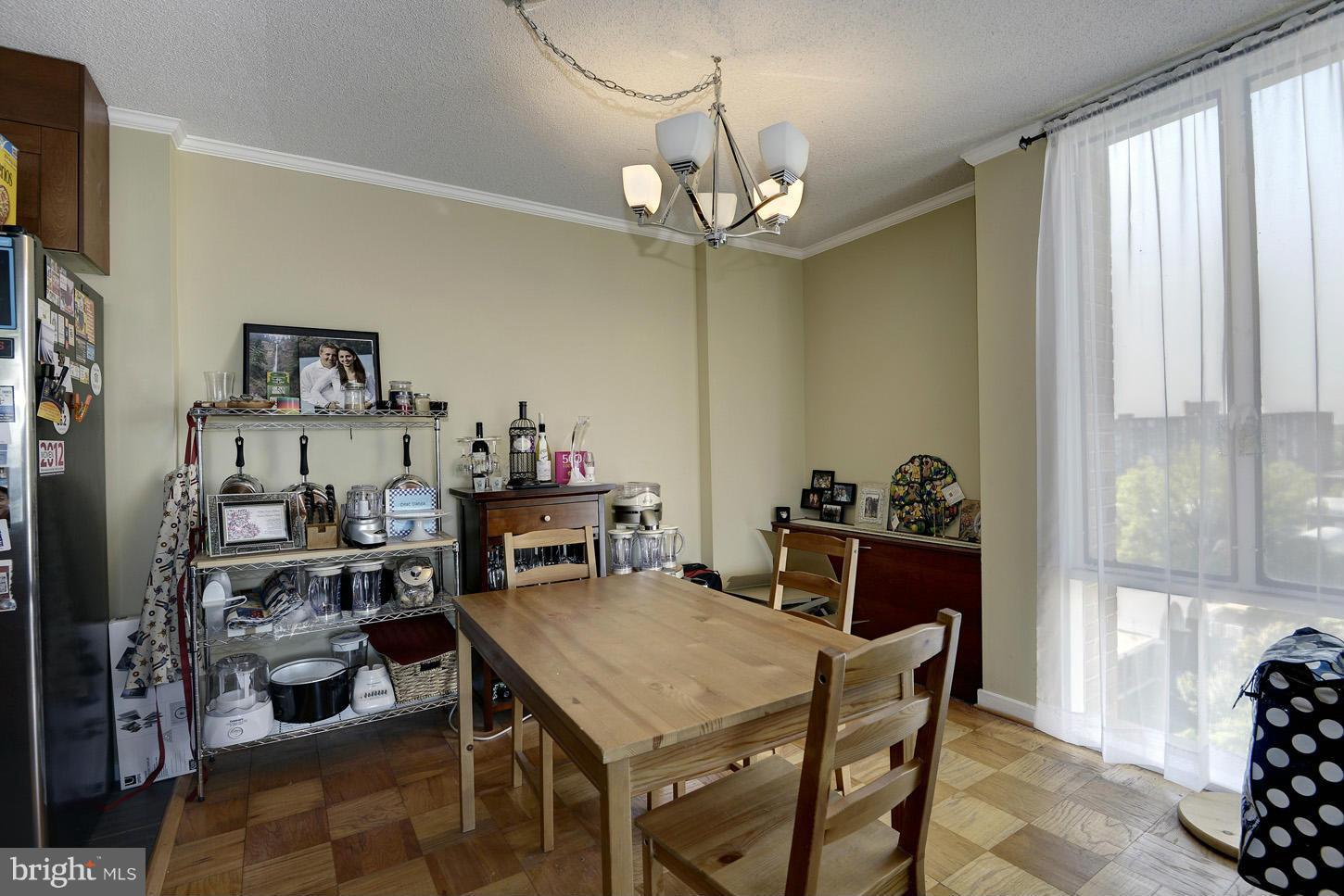 1250 4th Street Southwest, Unit W614 Washington, DC 20024 - Photo 6 of 22 a view of a dining room with furniture and a chandelier