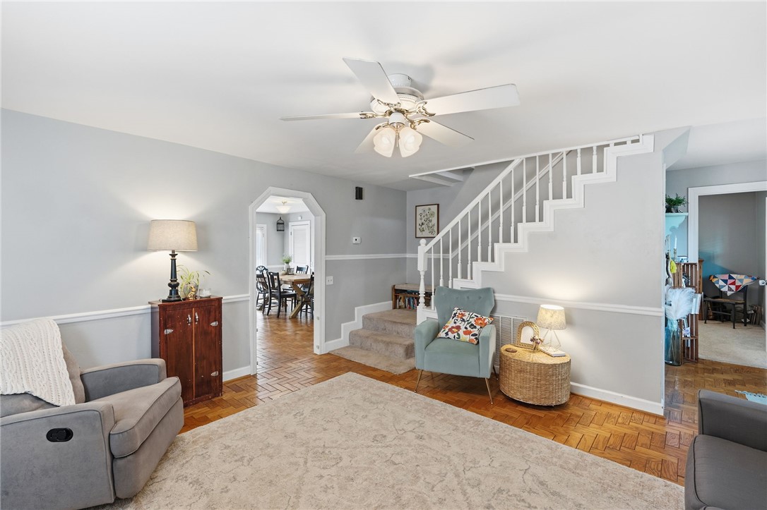 108 Tarrant Street Central, SC 29630 - Photo 10 of 42 Herringbone hardwood floors extend from the living area into the adjacent dining room, creating a seamless flow.