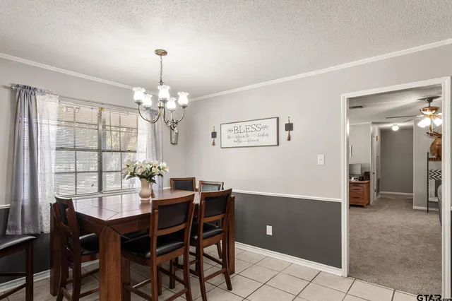 a dining room with furniture and chandelier