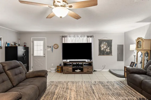 a living room with furniture a chandelier and a window