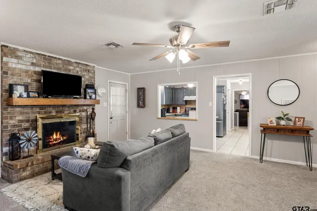 a living room with furniture a flat screen tv and a fireplace