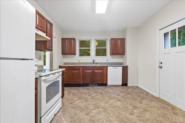 a kitchen with a stove sink and a refrigerator