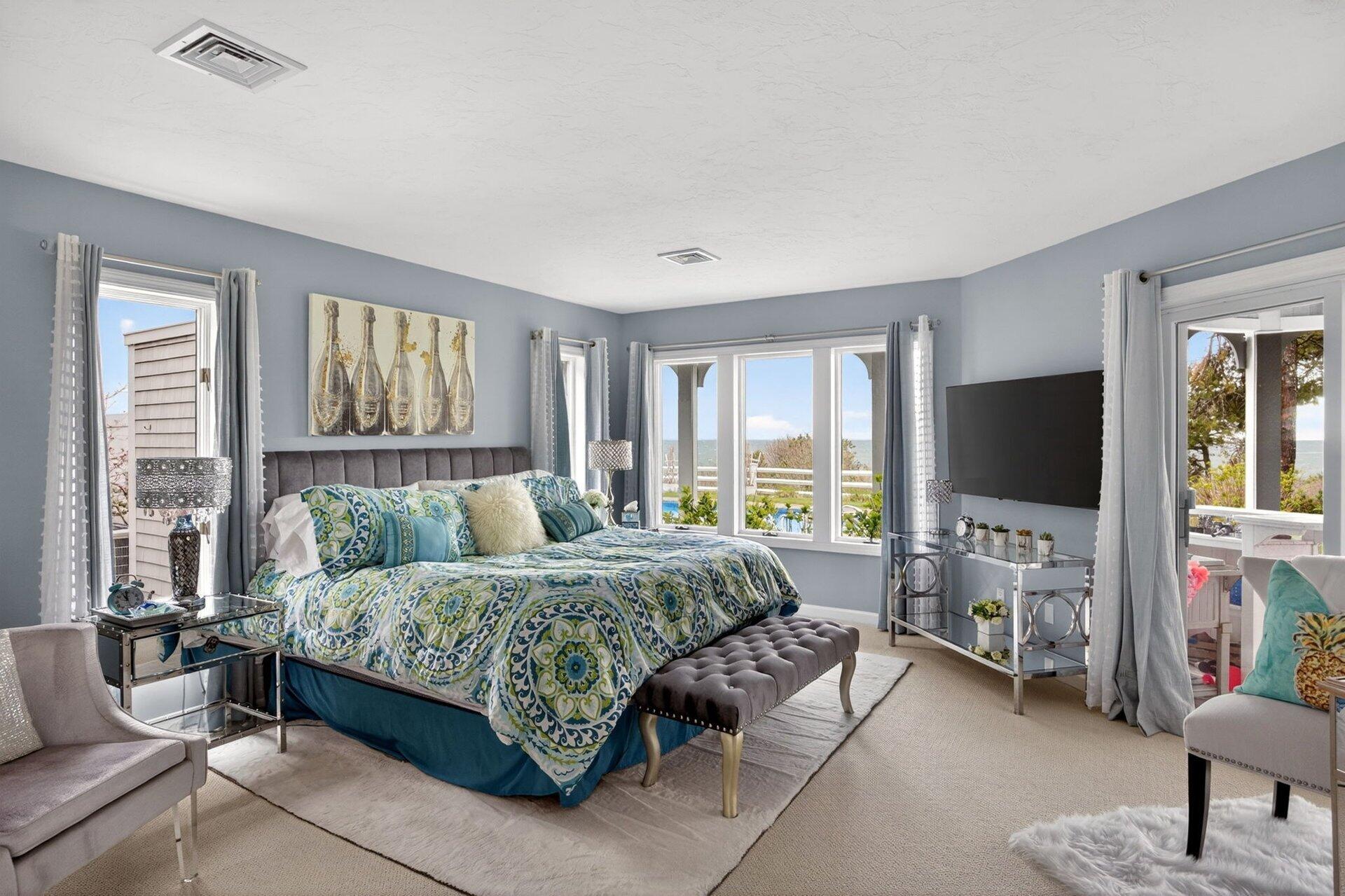 461 Wings Neck Road Pocasset, MA 02559 - Photo 33 of 42 a bedroom with a bed and large windows