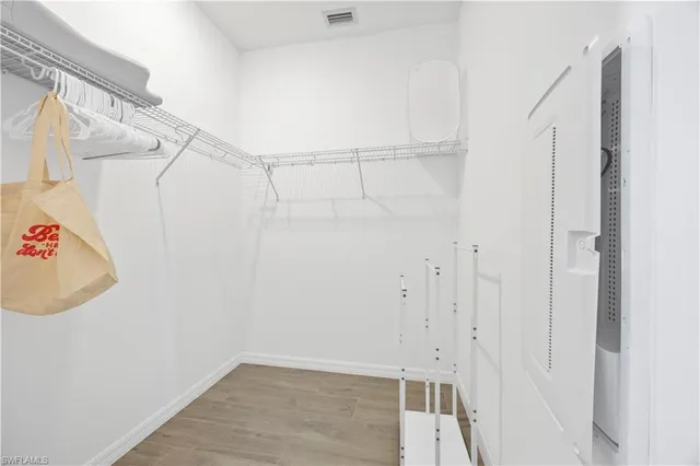 a view of walk in closet with empty racks