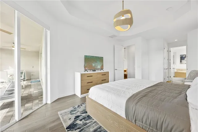 a spacious bedroom with a bed and glass door