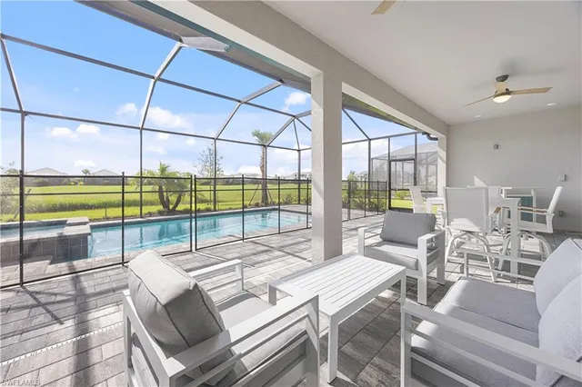 a view of a dining room with furniture water view and wooden floor