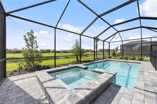 a view of swimming pool with a lounge chairs