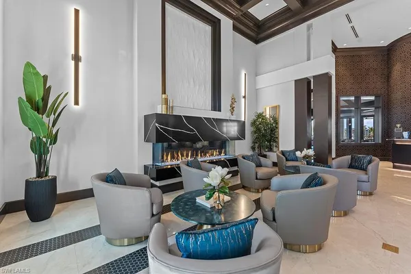 a living room with fireplace furniture and a potted plant