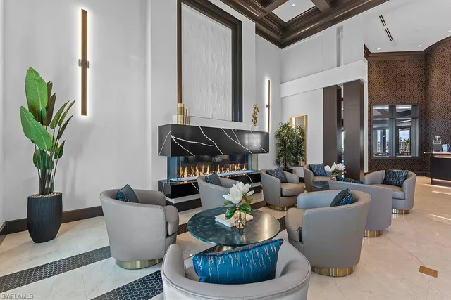 a living room with fireplace furniture and a potted plant