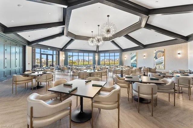 a very nice looking living room with a large window and a table