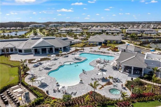 an aerial view of a house with a swimming pool outdoor seating and yard