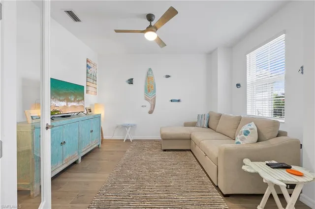 a living room with furniture and a wooden floor