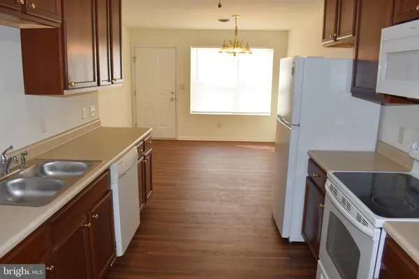 a kitchen with a sink stove and microwave