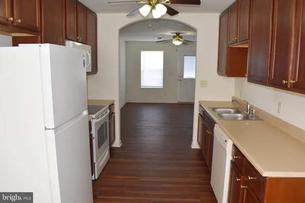 a kitchen with a refrigerator and a sink