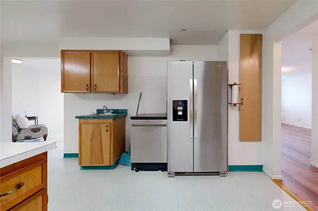 a kitchen with stainless steel appliances granite countertop a refrigerator and a stove