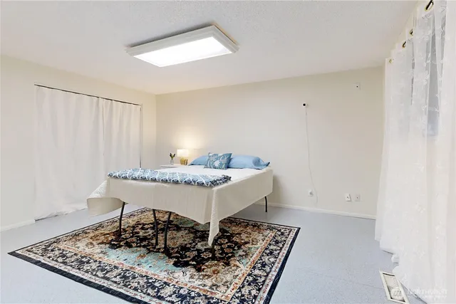 a living room with a table and a rug