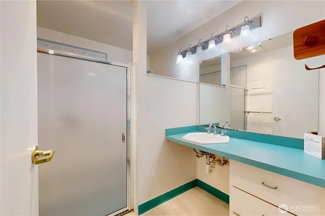 a bathroom with a sink and mirror