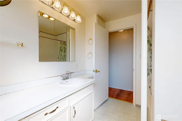 a bathroom with a sink a vanity and a mirror